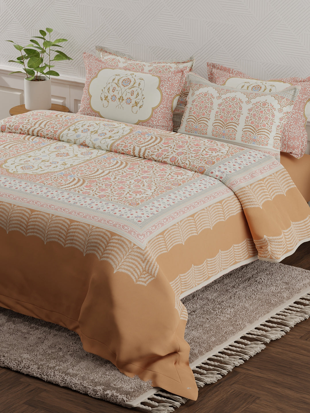 Patterned bedspread on a bed with decorative pillows in a room setting.