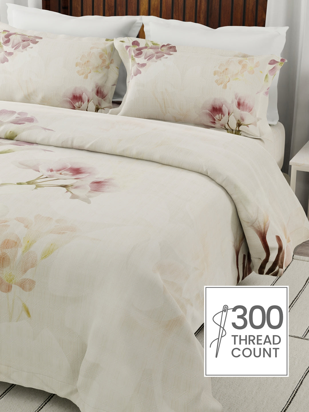 Floral bedding set with 300 thread count label on a bed.