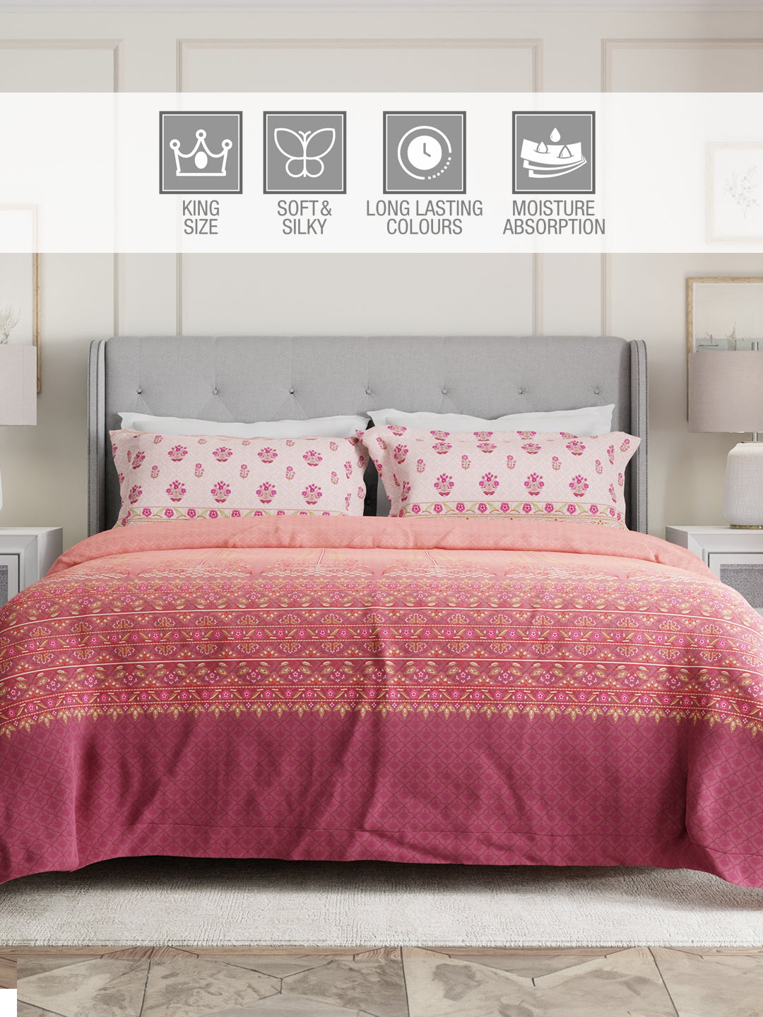 Pink patterned comforter on a bed with gray headboard and nightstands.
