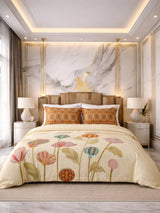 Decorative floral comforter on a bed in a stylish bedroom with marble wall.