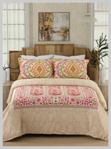 Bedroom with floral comforter and pillows on a wooden bed
