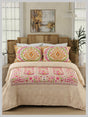 Bedroom with floral comforter and pillows on a wooden bed